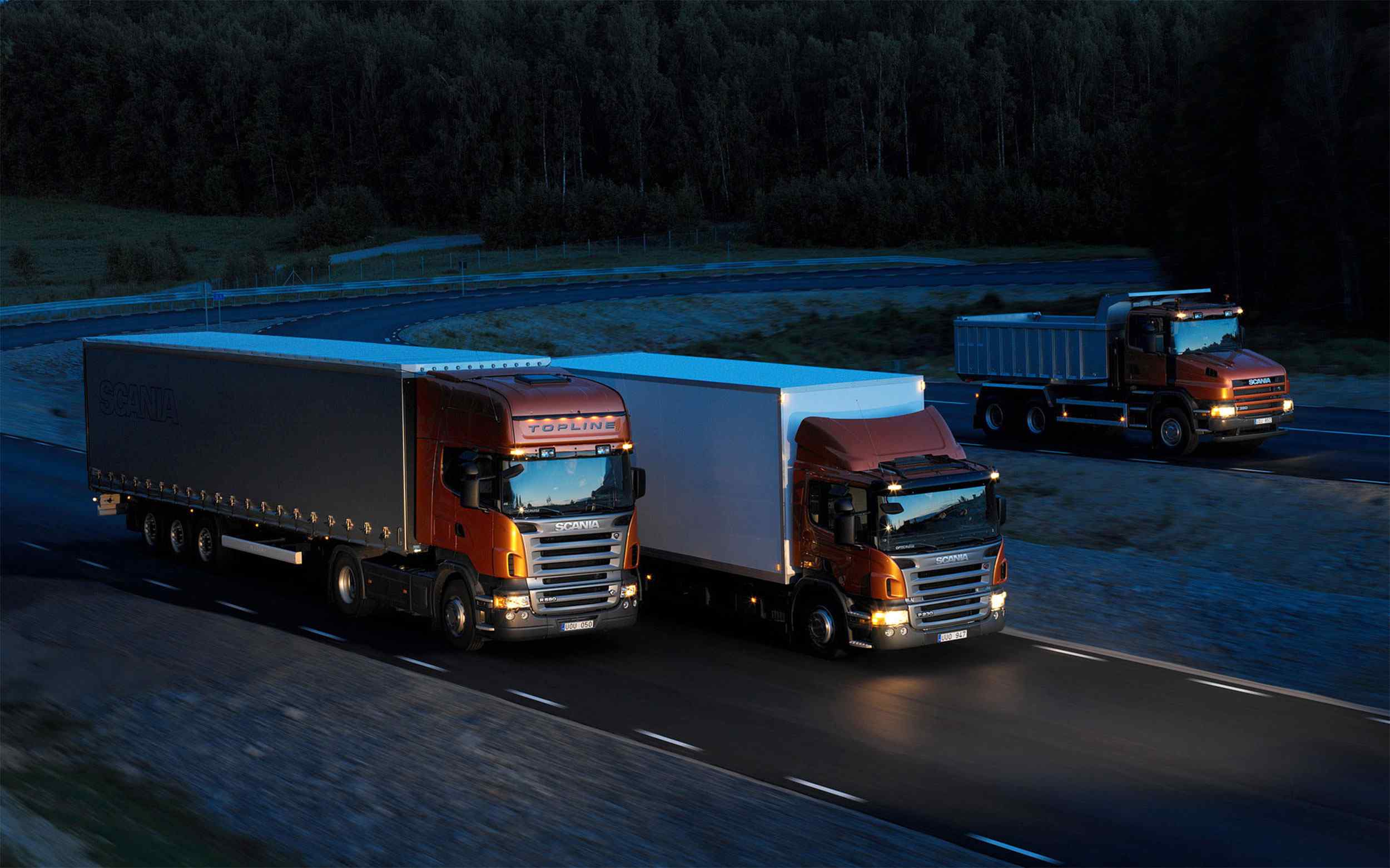 Three-orange-Scania-trucks.jpg